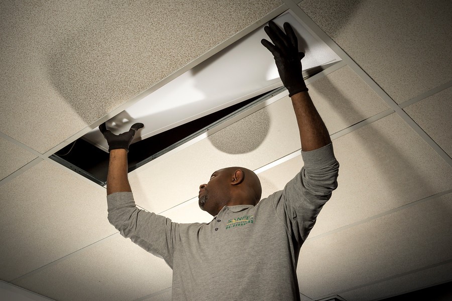 monteur installeert ledpaneel in plafond